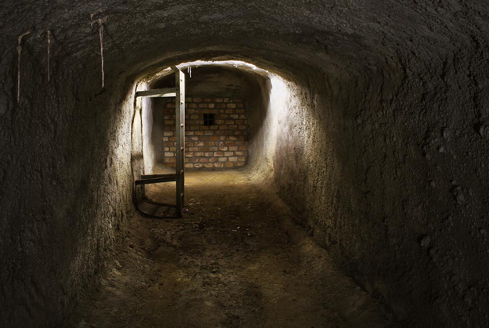 Stěny i podlaha chodby pod Pekařskou ulicí jsou nastříkány masivní vrstvou betonu, pod kterou jsou pohřbeny původní zděné stěny. Místy visí od stropu betonové krápníky.