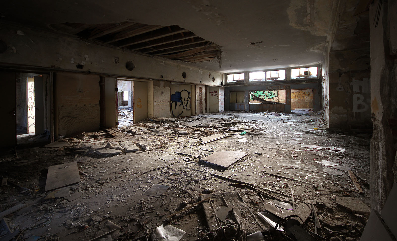 Totéž místo za denního svitu. Ze stropu se trhají kusy omítky zvící plochy křídla menšího letadla.