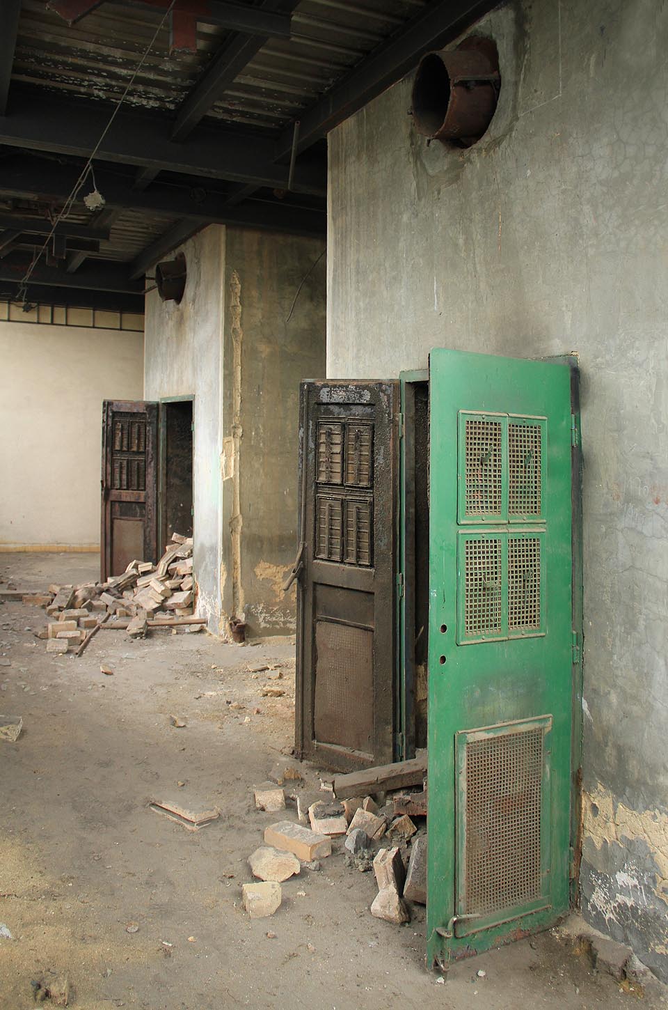 Vrata pod dvojicí kotlů pravděpodobně sloužila k vyvážení popela. V době započaté demolice (kotle už byste v kotelně hledali marně) byly zasypány šamotovými vyzdívkami.