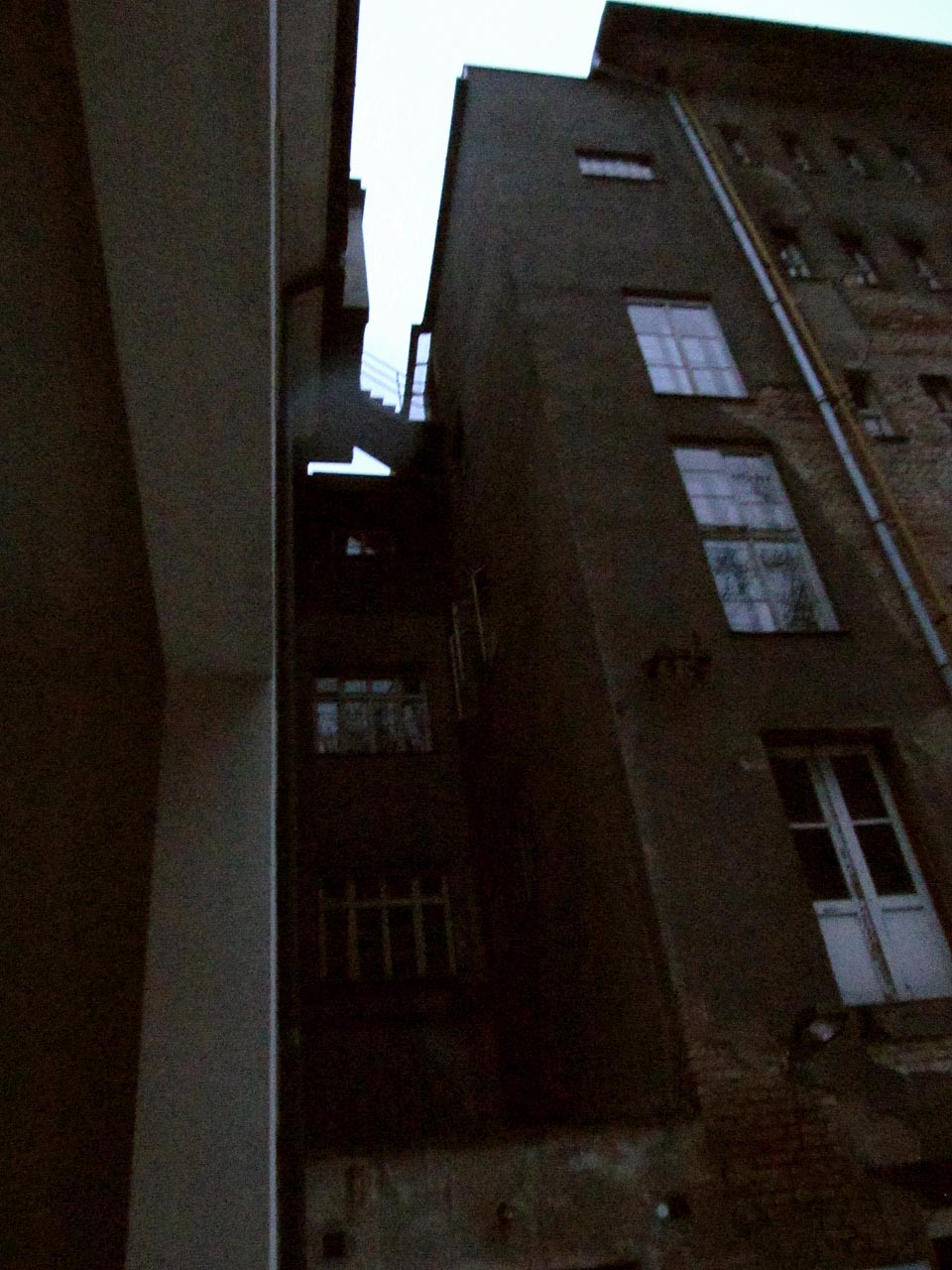 Zezadu připomíná nemocnice velkoměstskou zástavbu na sebe namačkaných domů. Schůdky na střeše působí přímo stínadelsky.