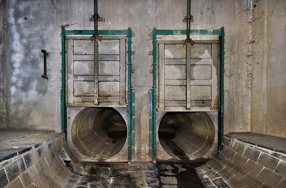 Do spojovacího potrubí za nerezovými stavidly by vlezl asi jenom šílenec. Klesá kamsi dolů pod hladinu.