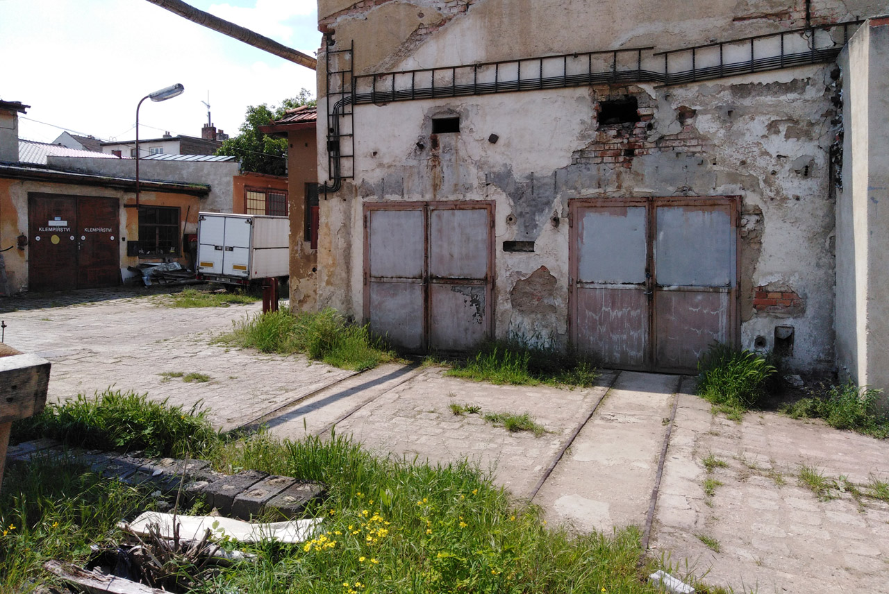 Kolej vedoucí z levých vrat se mírně stáčí směrem k pravé koleji - z toho lze bez nároku na jistotu usoudit, že se dřív obě koleje spojovaly na výhybce.