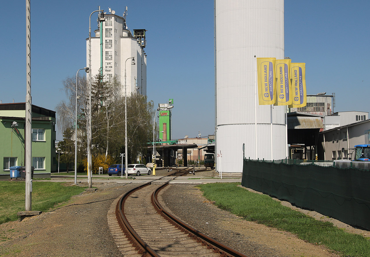 Za branou a přejezdem se kolej rozplétá na trojici rovnoběžných kusých kolejí procházejících nakládacím a vykládacím prostorem.